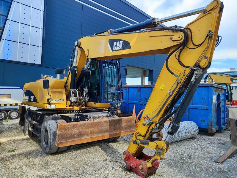 Caterpillar M318D MH - Pyöräalustainen kaivinkone: kuva Caterpillar M318D MH - Pyöräalustainen kaivinkone Caterpillar M318D MH - Pyöräalustainen kaivinkone: kuva Caterpillar M318D MH - Pyöräalustainen kaivinkone