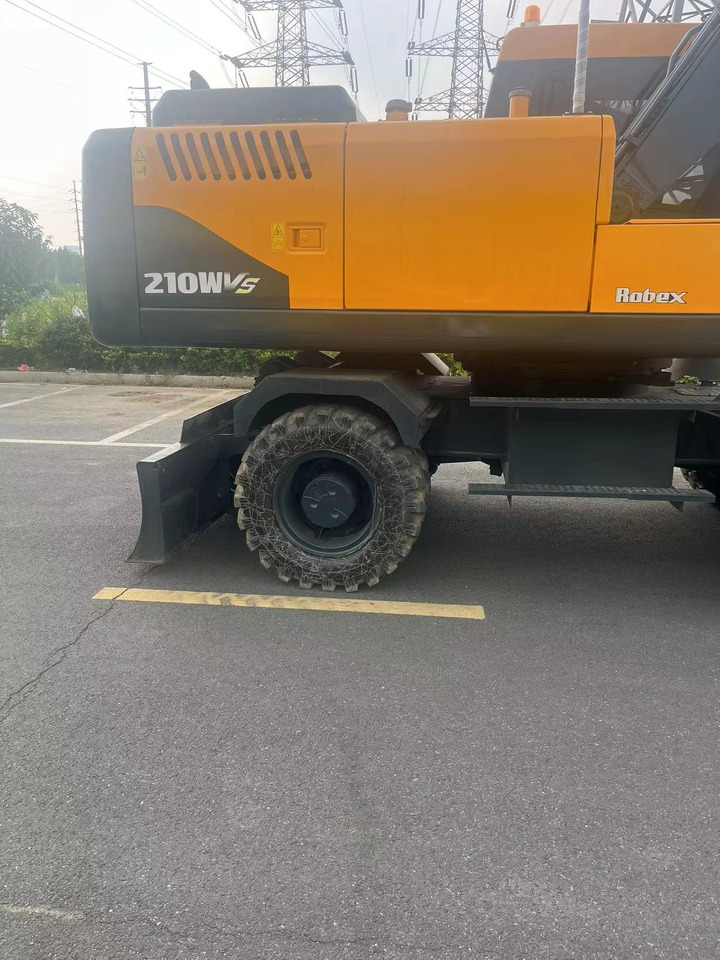 HYUNDAI R210W - Pyöräalustainen kaivinkone: kuva HYUNDAI R210W - Pyöräalustainen kaivinkone HYUNDAI R210W - Pyöräalustainen kaivinkone: kuva HYUNDAI R210W - Pyöräalustainen kaivinkone