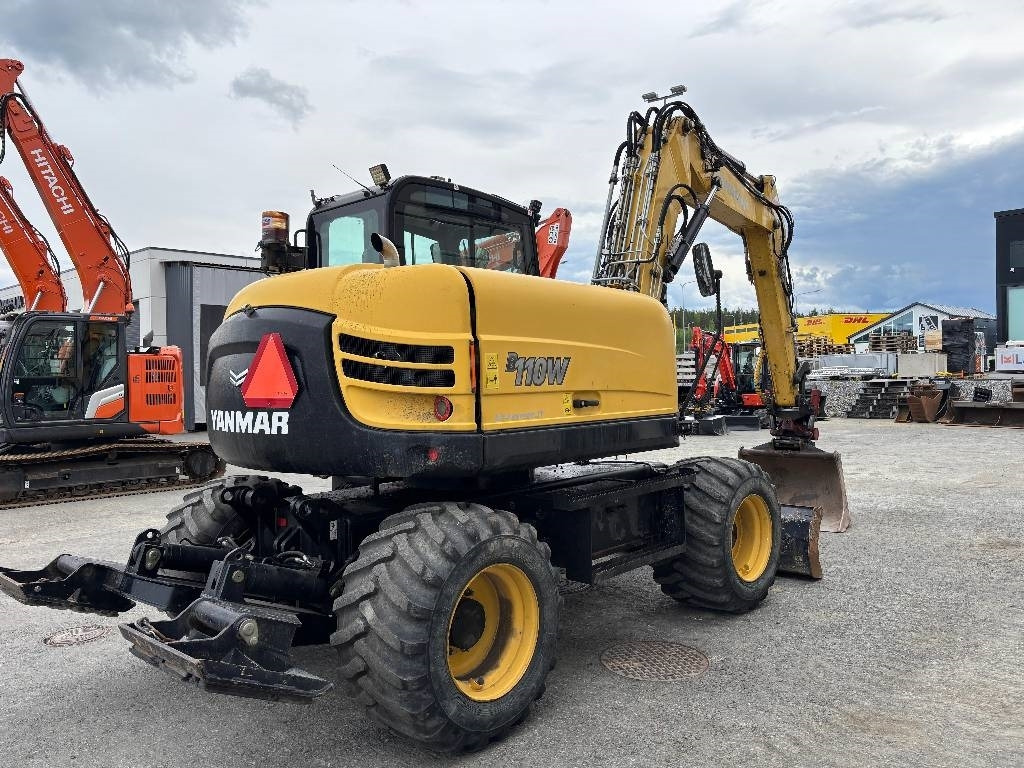 Yanmar B110W PYÖRITTÄJÄLLÄ - Pyöräalustainen kaivinkone: kuva Yanmar B110W PYÖRITTÄJÄLLÄ - Pyöräalustainen kaivinkone Yanmar B110W PYÖRITTÄJÄLLÄ - Pyöräalustainen kaivinkone: kuva Yanmar B110W PYÖRITTÄJÄLLÄ - Pyöräalustainen kaivinkone
