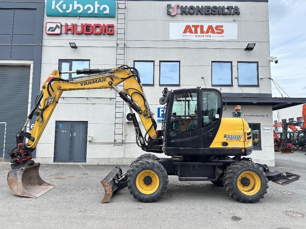 Yanmar B110W PYÖRITTÄJÄLLÄ - Pyöräalustainen kaivinkone: kuva Yanmar B110W PYÖRITTÄJÄLLÄ - Pyöräalustainen kaivinkone Yanmar B110W PYÖRITTÄJÄLLÄ - Pyöräalustainen kaivinkone: kuva Yanmar B110W PYÖRITTÄJÄLLÄ - Pyöräalustainen kaivinkone