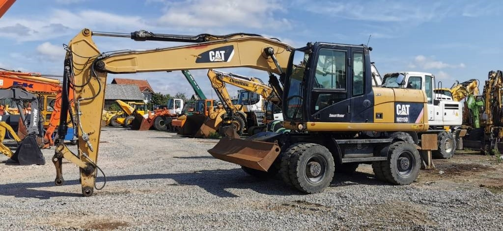 CAT M 315 D - Pyöräalustainen kaivinkone: kuva CAT M 315 D - Pyöräalustainen kaivinkone CAT M 315 D - Pyöräalustainen kaivinkone: kuva CAT M 315 D - Pyöräalustainen kaivinkone