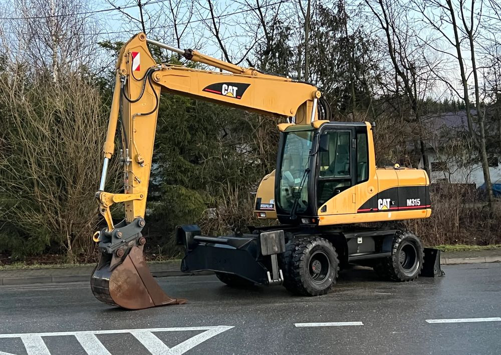 Caterpillar CAT M315C CATERPILLAR SPROWADZONY Bardzo Dobry Stan - Pyöräalustainen kaivinkone: kuva Caterpillar CAT M315C CATERPILLAR SPROWADZONY Bardzo Dobry Stan - Pyöräalustainen kaivinkone Caterpillar CAT M315C CATERPILLAR SPROWADZONY Bardzo Dobry Stan - Pyöräalustainen kaivinkone: kuva Caterpillar CAT M315C CATERPILLAR SPROWADZONY Bardzo Dobry Stan - Pyöräalustainen kaivinkone