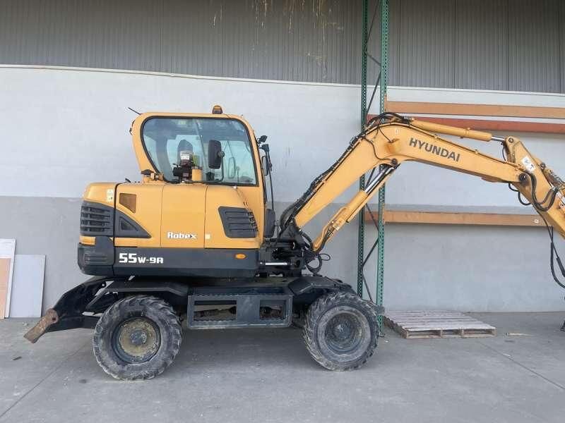 Hyundai R55W-9A - Pyöräalustainen kaivinkone: kuva Hyundai R55W-9A - Pyöräalustainen kaivinkone Hyundai R55W-9A - Pyöräalustainen kaivinkone: kuva Hyundai R55W-9A - Pyöräalustainen kaivinkone