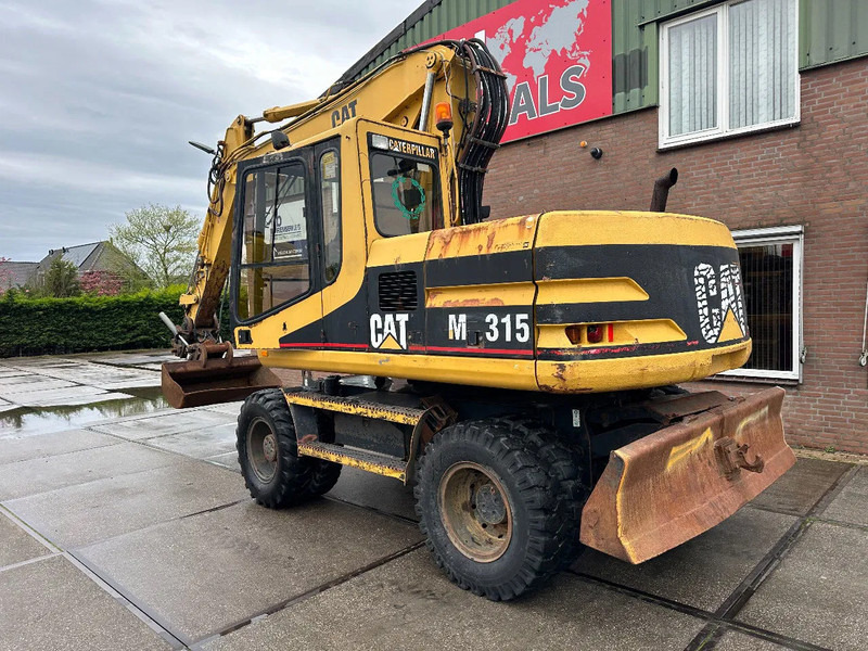 Caterpillar M315 +ROTO CE - Pyöräalustainen kaivinkone: kuva Caterpillar M315 +ROTO CE - Pyöräalustainen kaivinkone Caterpillar M315 +ROTO CE - Pyöräalustainen kaivinkone: kuva Caterpillar M315 +ROTO CE - Pyöräalustainen kaivinkone