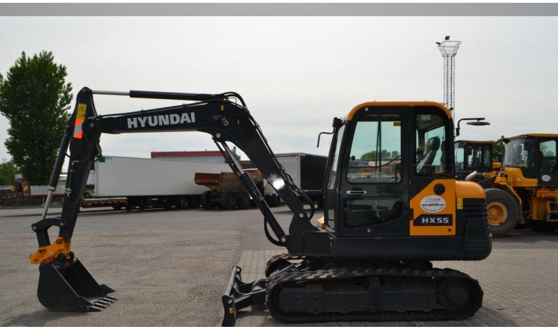 Hyundai HX55 Mini lánctalpas forgókotró - Minikuormaaja: kuva Hyundai HX55 Mini lánctalpas forgókotró - Minikuormaaja Hyundai HX55 Mini lánctalpas forgókotró - Minikuormaaja: kuva Hyundai HX55 Mini lánctalpas forgókotró - Minikuormaaja